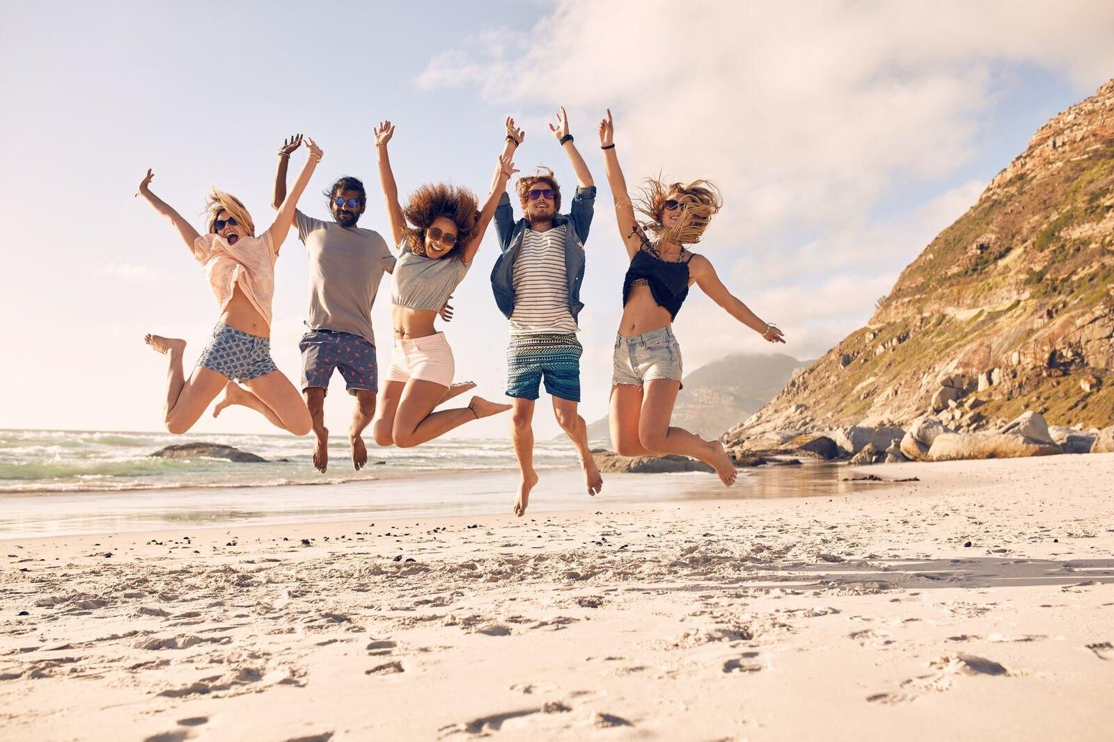 A group of digital nomads enjoying entertainment and fun on a beach, symbolizing the freedom and lifestyle of Digital Nomad Entertainment
